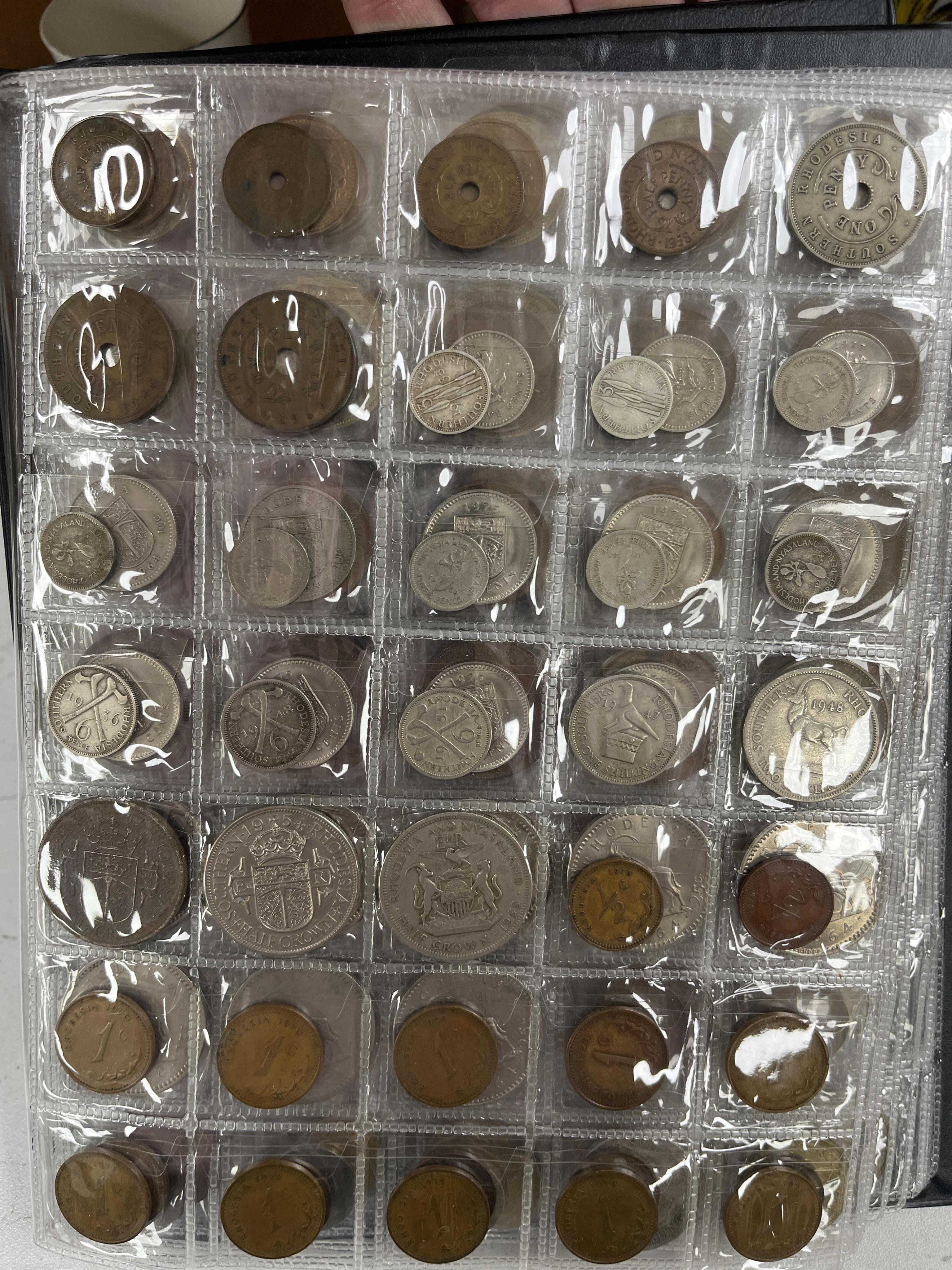 Southern Rhodesia, South Africa and Europe coins, early to late 20th century, and Victoria, and later pennies, Rhodesia, Japan, Zimbabwea banknotes, in two albums